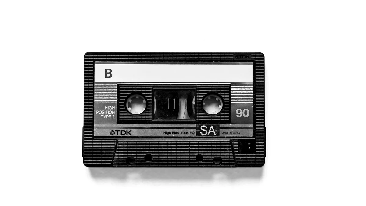 A cassette tape photographed on a light background.
